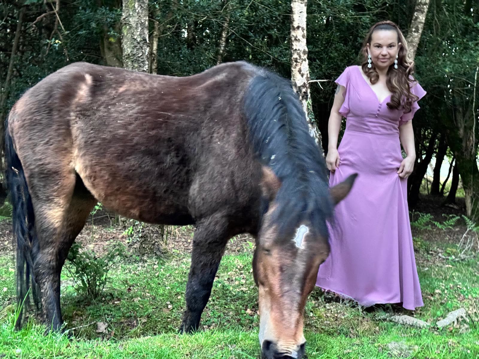 Aynaz with a wild pony in an open field